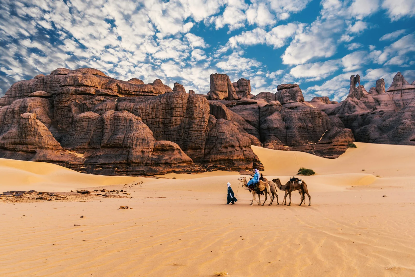 قافلة وسط صخور ورمال الصحراء الجزائرية